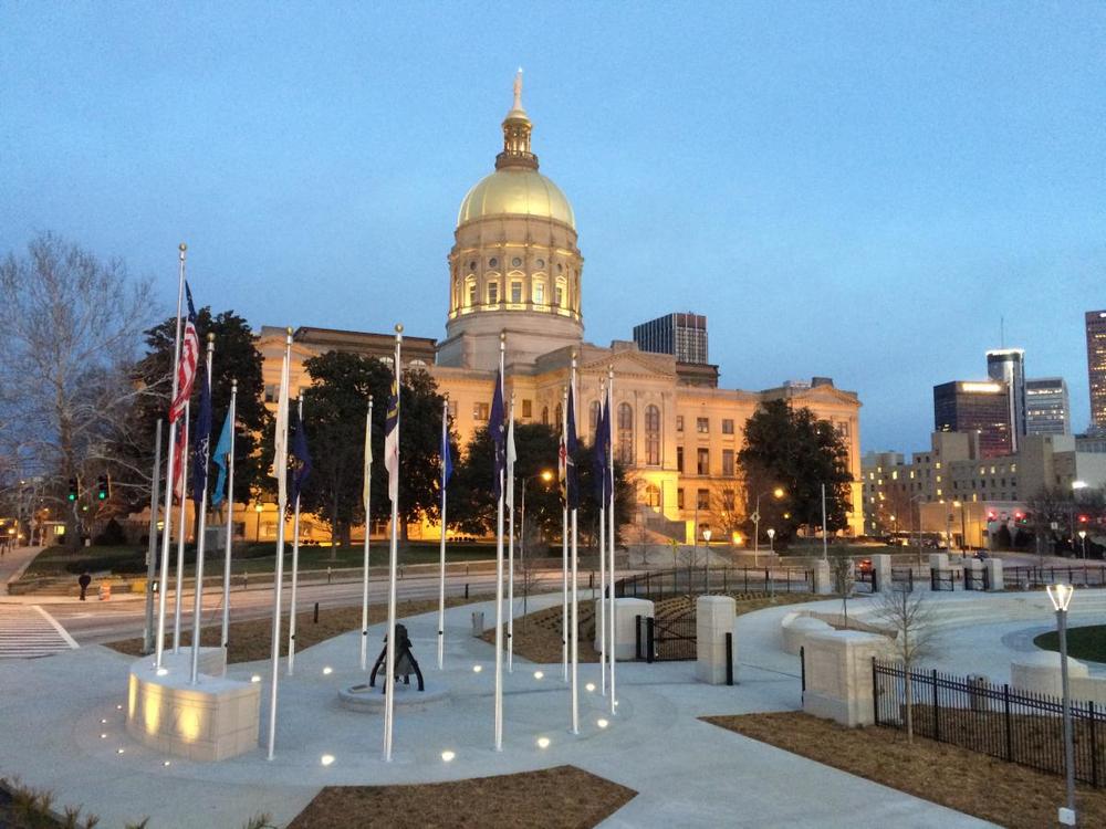 Photo of Liberty Plaza Flags with Capitol in background